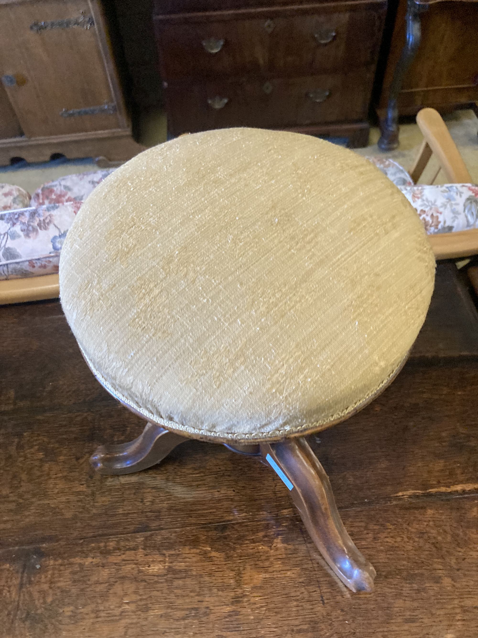 A Victorian revolving mahogany adjustable piano stool